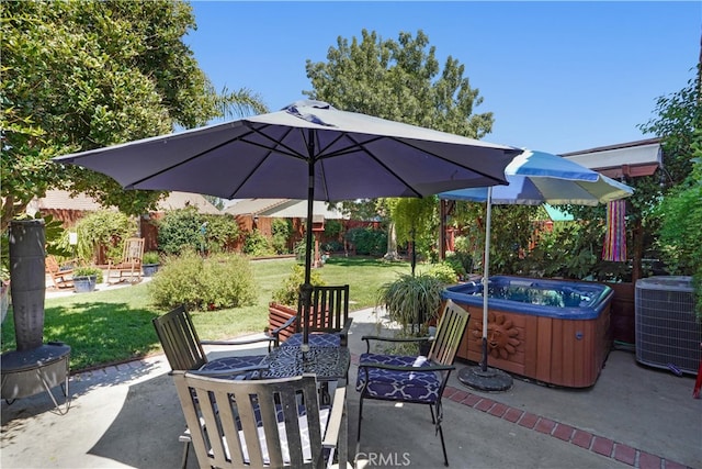 view of patio with cooling unit and a hot tub