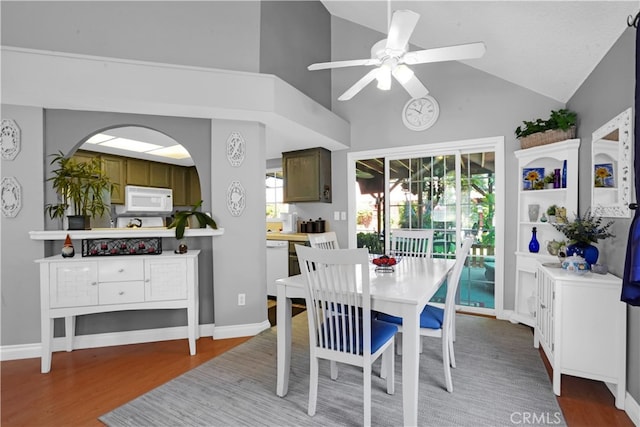 dining room featuring lofted ceiling, ceiling fan, and hardwood / wood-style flooring