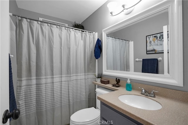 bathroom featuring vanity, toilet, and a shower with shower curtain