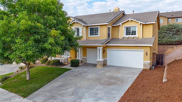 view of front of property featuring an attached garage, stone siding, a tiled roof, driveway, and stucco siding