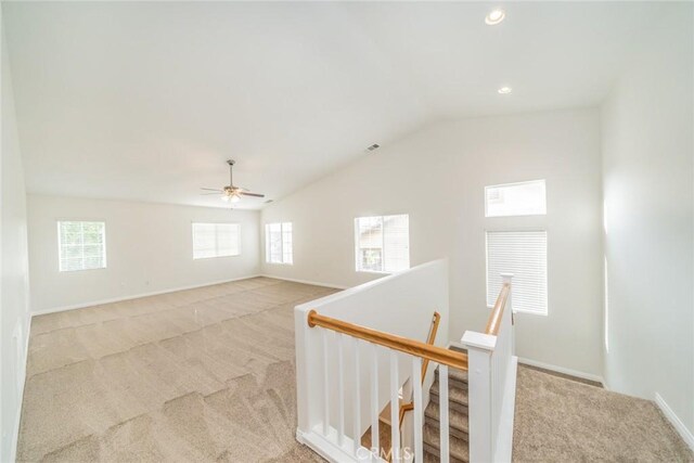 interior space featuring light carpet and lofted ceiling