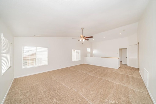 unfurnished room with lofted ceiling, recessed lighting, visible vents, light carpet, and baseboards