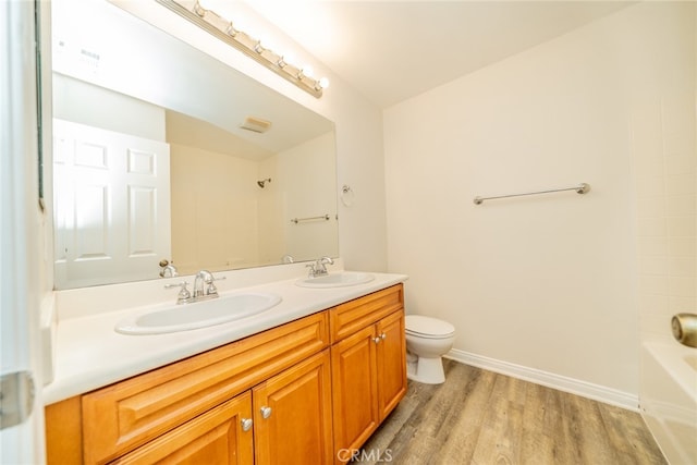 full bathroom featuring toilet, shower / bathing tub combination, vanity, and wood-type flooring