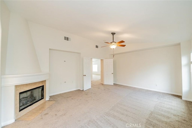 unfurnished living room with baseboards, visible vents, a fireplace, and carpet flooring