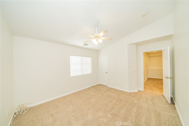 unfurnished room featuring ceiling fan, lofted ceiling, and light colored carpet