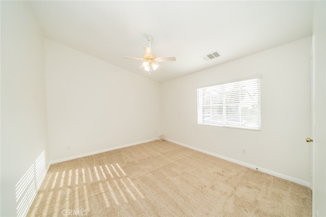 empty room with light colored carpet and ceiling fan