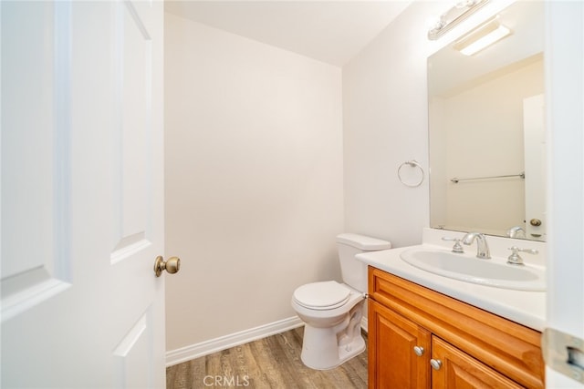 bathroom featuring vanity, toilet, and wood-type flooring