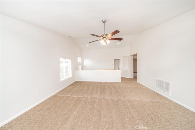 carpeted empty room with ceiling fan and vaulted ceiling