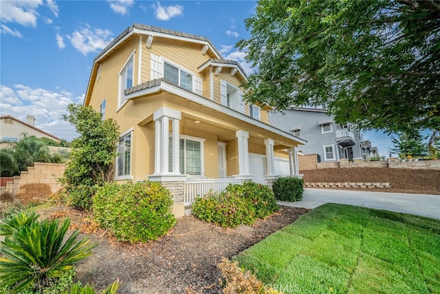 view of front of home featuring covered porch and a front yard