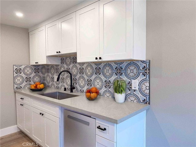31377 Los Rios St Unit 64F, San Juan Capistrano, CA 92675 - kitchen with a sink, dishwasher, backsplash, white cabinetry, and light countertops