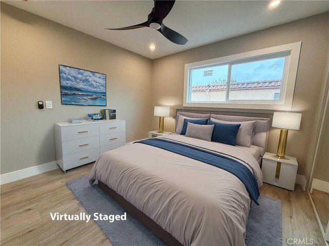 bedroom with recessed lighting, light wood-style floors, and baseboards