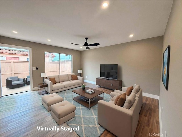 living room featuring recessed lighting, a ceiling fan, baseboards, and wood finished floors