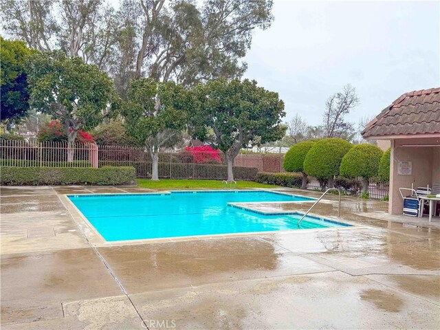 pool featuring a patio area and fence