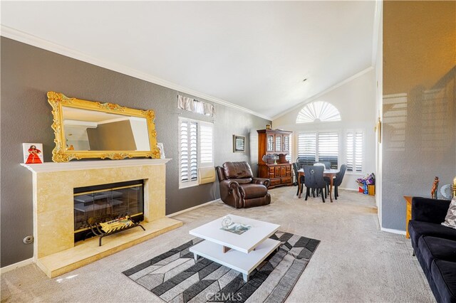 carpeted living room with a fireplace, lofted ceiling, and ornamental molding