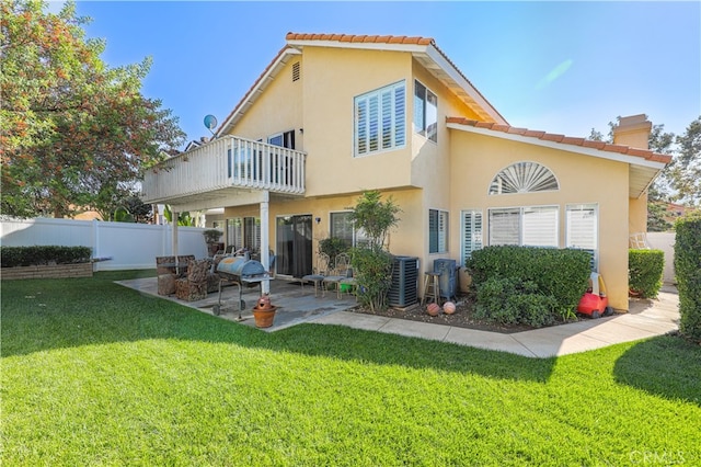 back of house featuring a lawn, central air condition unit, a balcony, and a patio