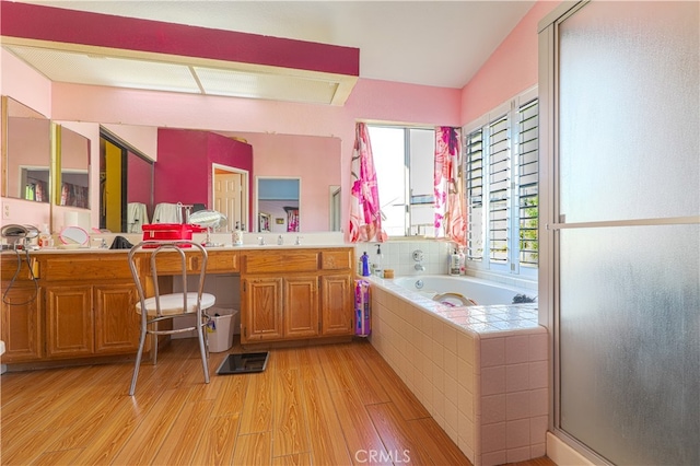 bathroom with wood-type flooring, vanity, shower with separate bathtub, and lofted ceiling