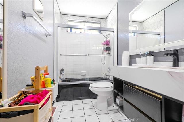 full bathroom with shower / bath combination with glass door, vanity, toilet, and tile patterned flooring