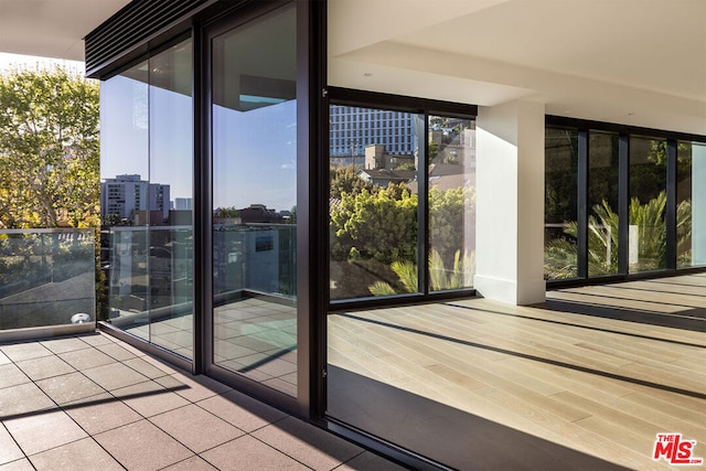 interior space featuring expansive windows, hardwood / wood-style flooring, and plenty of natural light