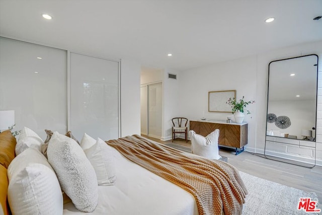 bedroom featuring a closet and light wood-type flooring