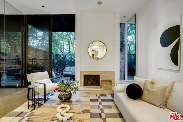 sitting room with floor to ceiling windows and hardwood / wood-style floors