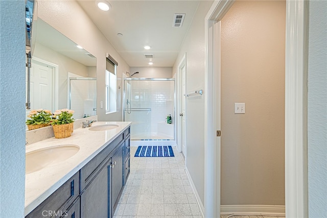 bathroom featuring vanity and a shower with shower door