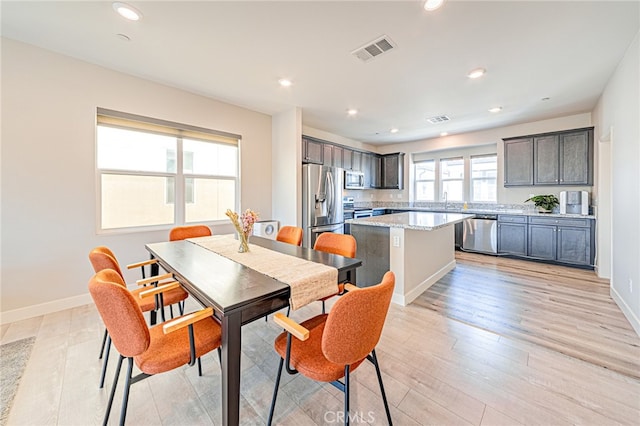 dining area with light hardwood / wood-style floors