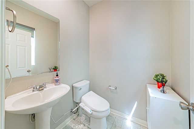 bathroom featuring sink and toilet