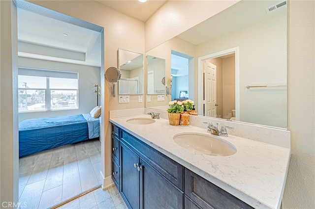 bathroom featuring vanity, hardwood / wood-style floors, and toilet