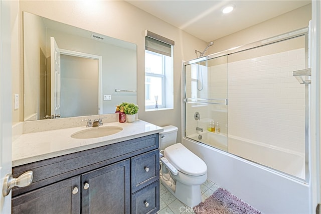 full bathroom featuring bath / shower combo with glass door, vanity, toilet, and tile patterned floors