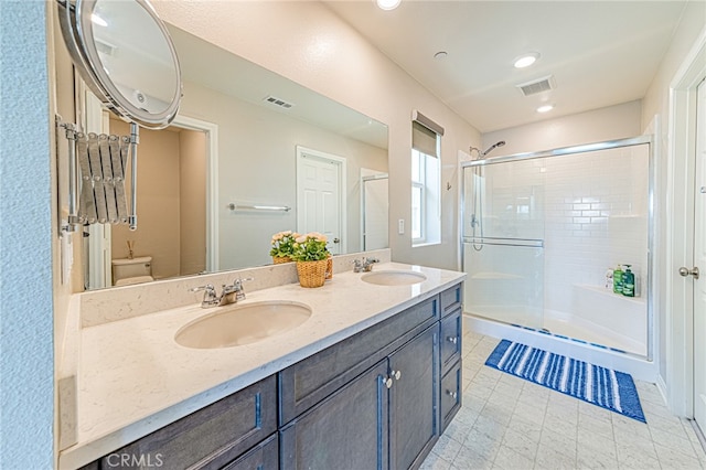 bathroom with vanity, toilet, an enclosed shower, and tile patterned floors