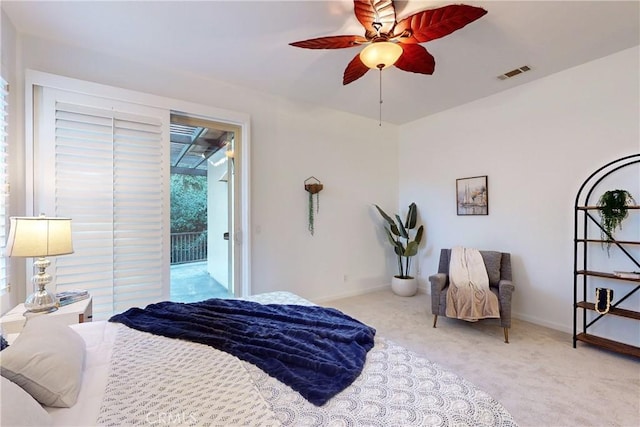 bedroom featuring access to exterior, light carpet, and ceiling fan