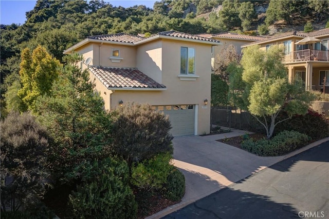 mediterranean / spanish-style house with a garage