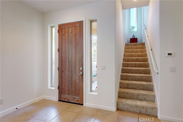 entryway featuring a healthy amount of sunlight and light tile patterned flooring