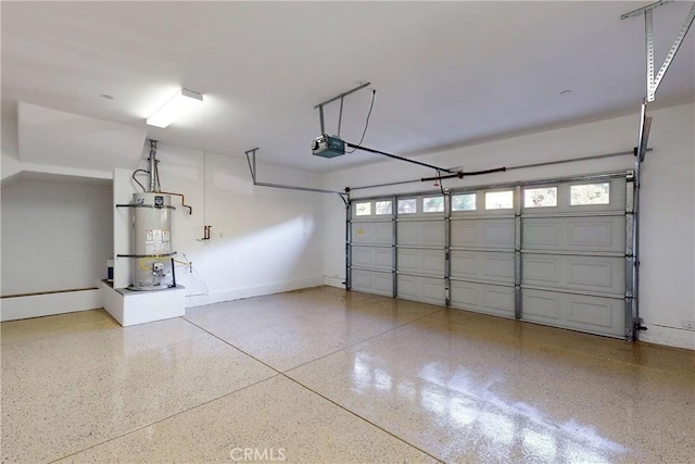 garage with a garage door opener and water heater