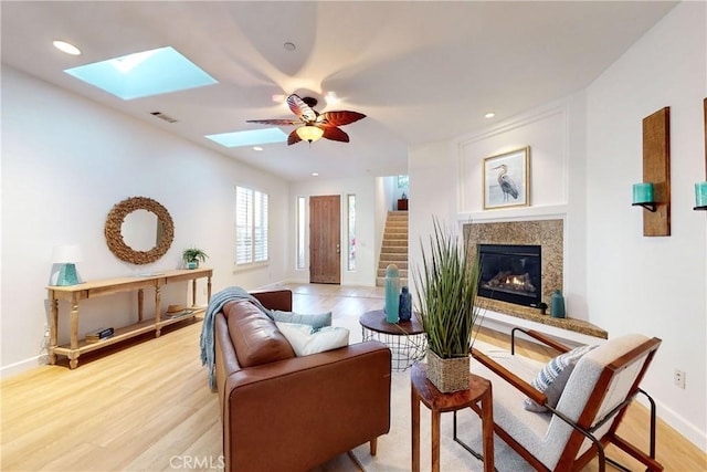 living room featuring ceiling fan and light hardwood / wood-style floors