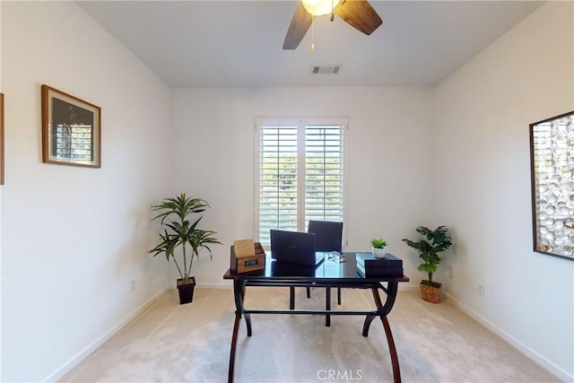 carpeted office space featuring ceiling fan