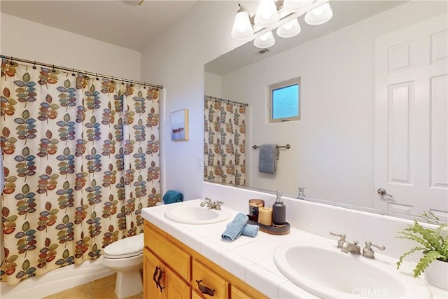 full bathroom with tile patterned flooring, vanity, toilet, and shower / bath combo with shower curtain