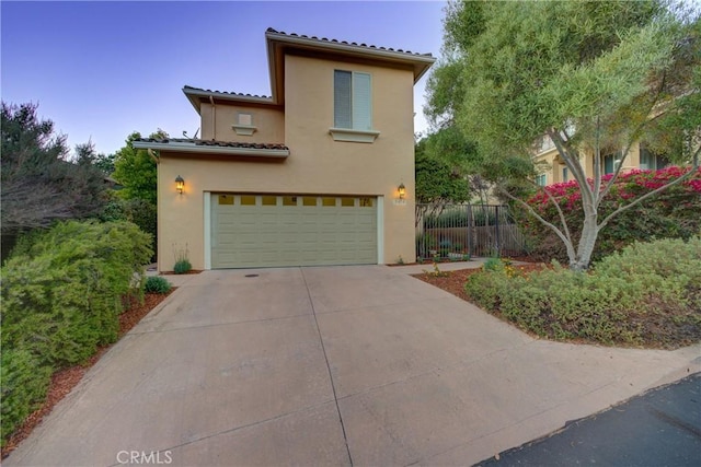 mediterranean / spanish house featuring a garage