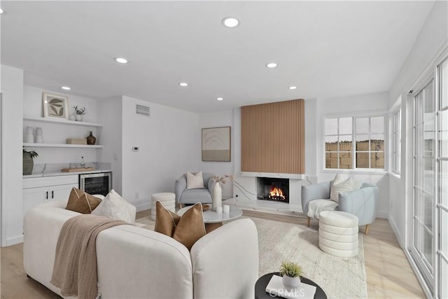 15562 Placid Cir, Huntington Beach, CA 92647 - living area featuring a large fireplace, recessed lighting, visible vents, and indoor bar