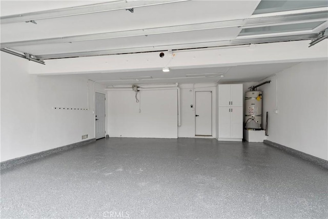 15562 Placid Cir, Huntington Beach, CA 92647 - garage with baseboards and water heater