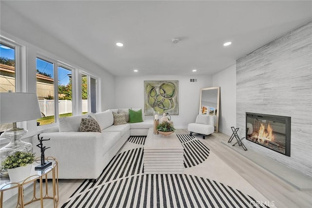 living room with a fireplace and light hardwood / wood-style floors