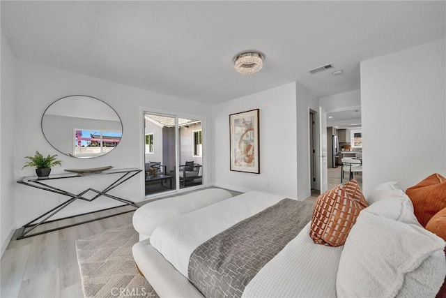 bedroom with light hardwood / wood-style flooring and multiple windows