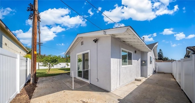 view of side of home featuring a patio