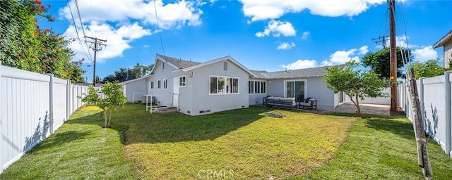 rear view of property with a lawn