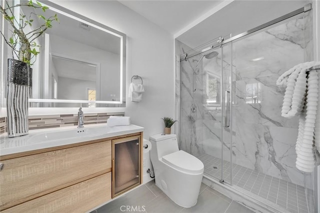 bathroom with tile patterned flooring, vanity, toilet, and a shower with door