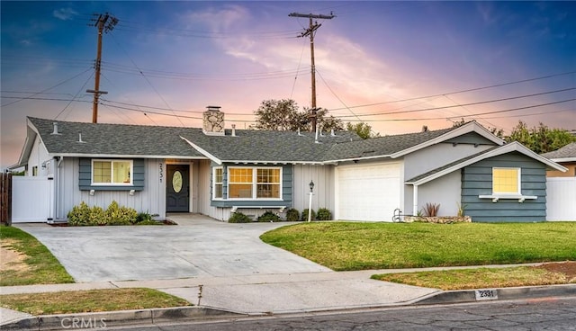 ranch-style house with a lawn and a garage