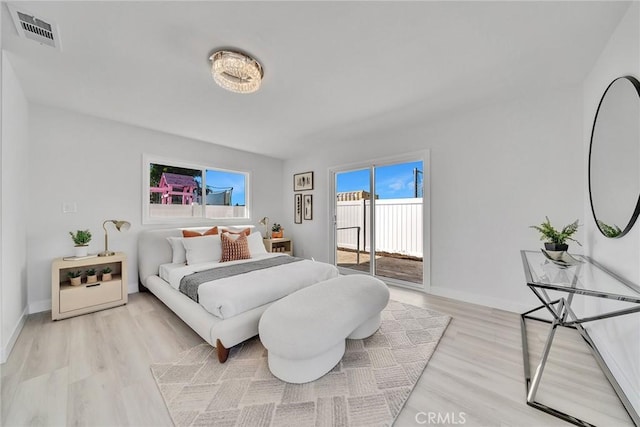 bedroom with access to outside and light hardwood / wood-style floors