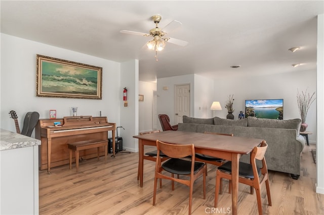 dining room featuring light hardwood / wood-style floors and ceiling fan