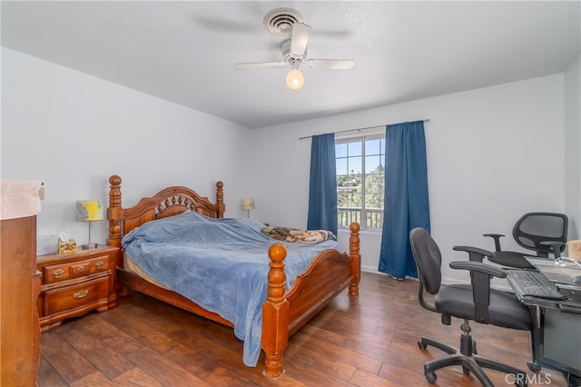 bedroom featuring ceiling fan and dark wood-type flooring