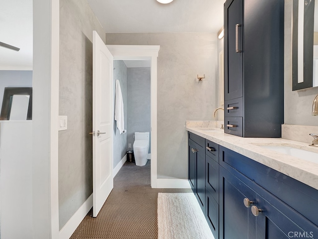 bathroom featuring tile patterned flooring, vanity, and toilet